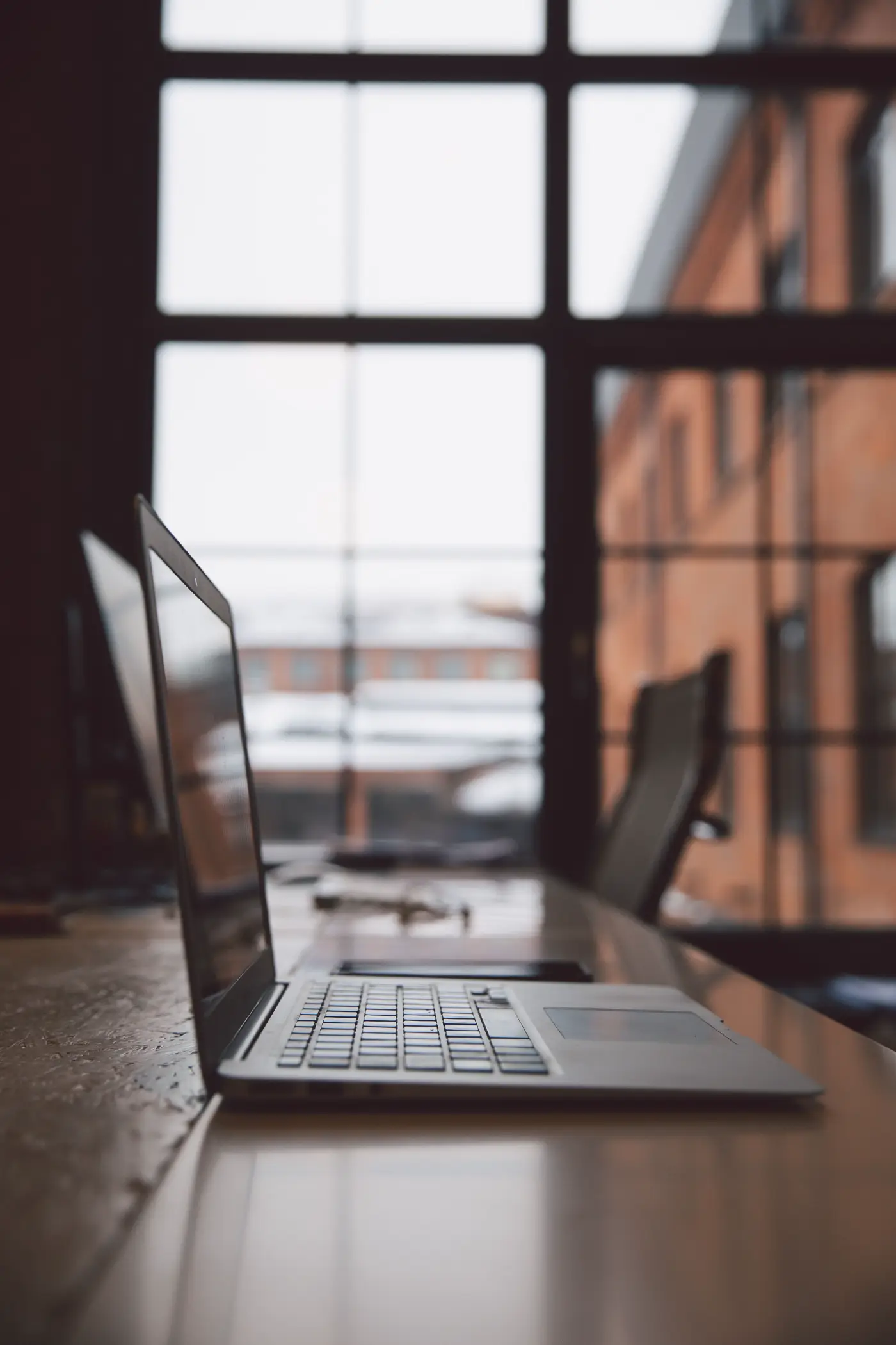 A desk beside a tall window, the scale of a Node.