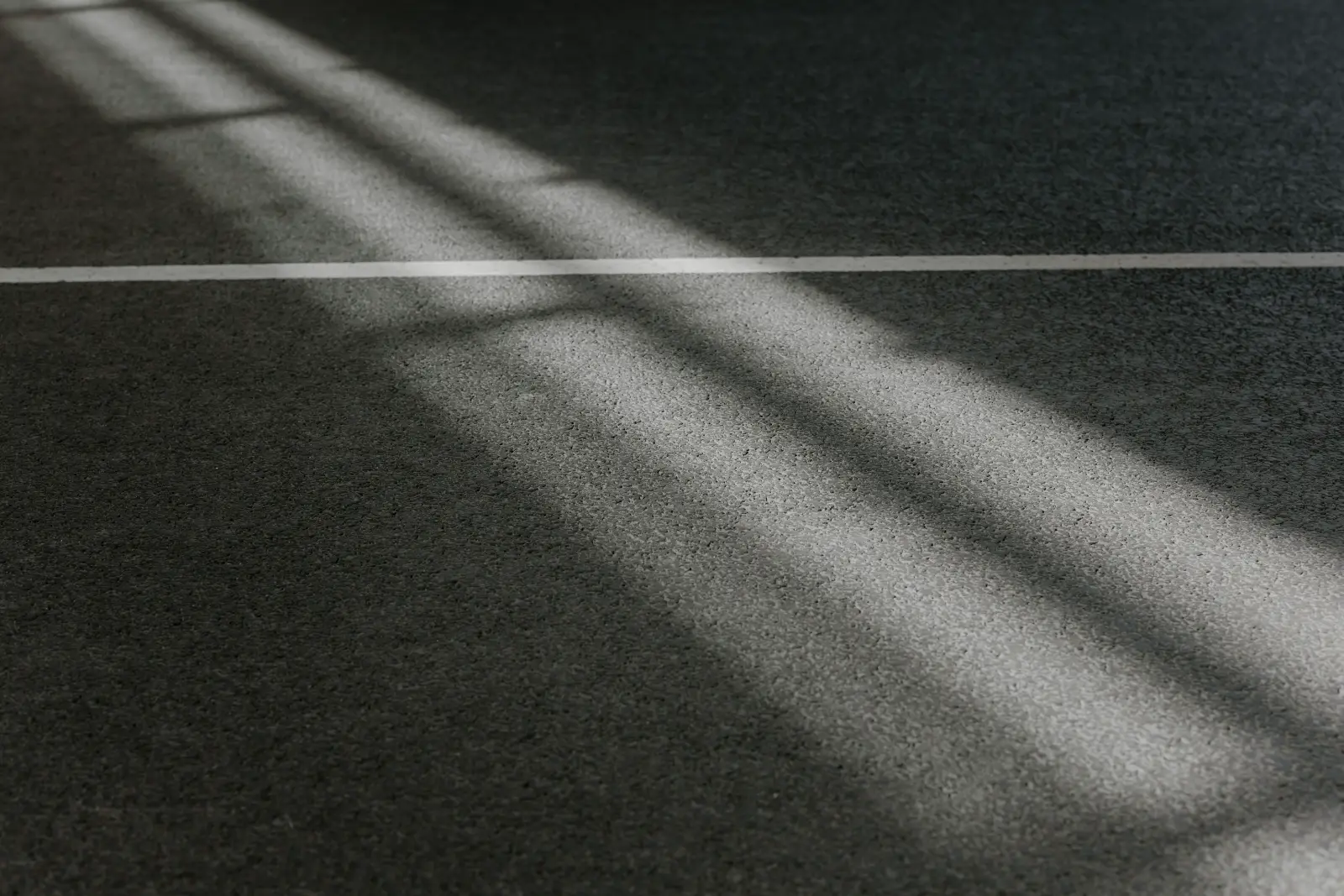 Raking daylight across a wide empty floor.